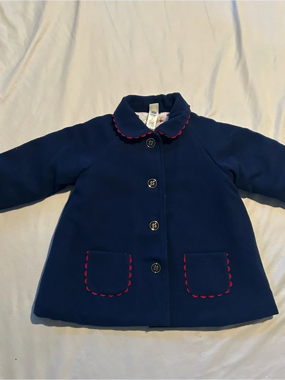 Little Me Navy Pea Coat with Red Scallop Trim and Bow.
